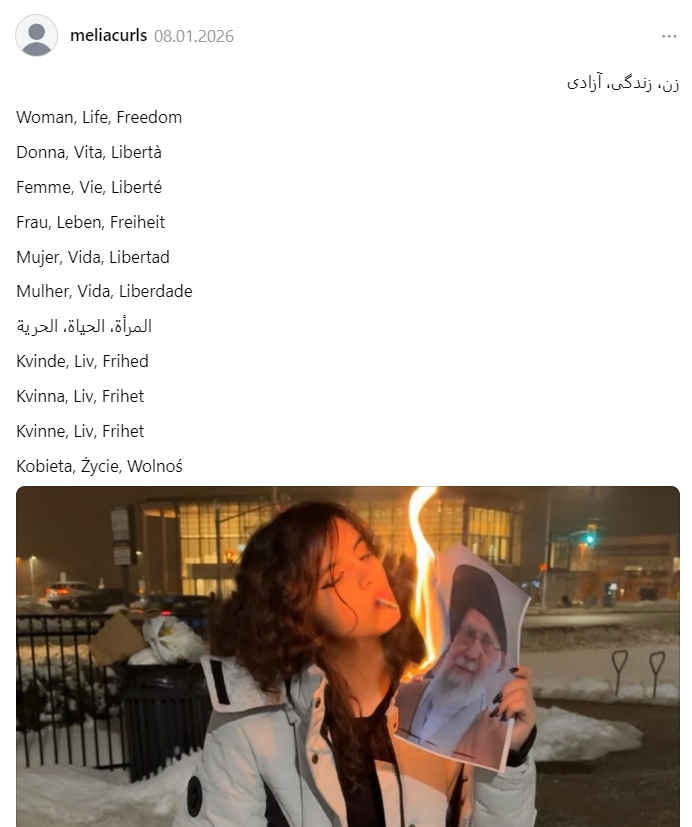 Девушка прикуривает сигарету от портрета Хаменеи